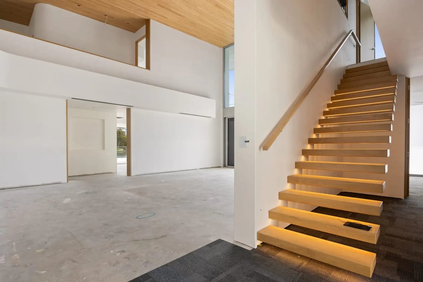32 Deep Water Circuit, Pelican Waters: the floating timber staircase and the double-height void, ready for the next owner’s finishes